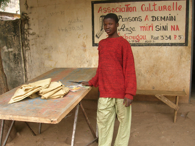 Oumar brings school work for Bassidy to check